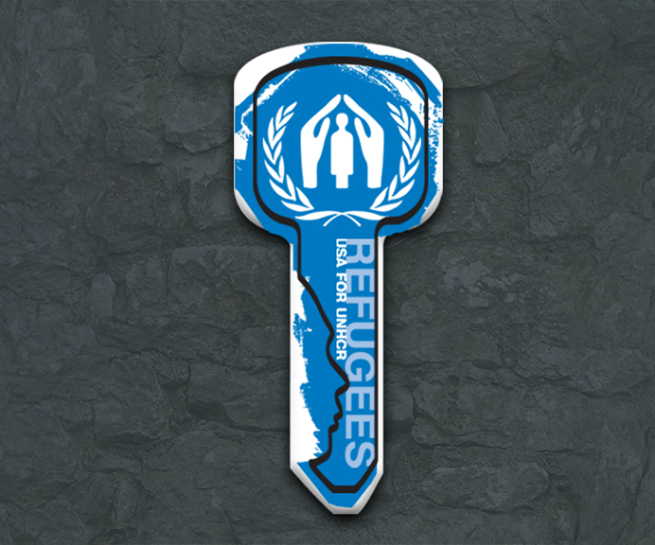 A graphic of a key with the outline depicting a face profile, the UNHCR logo, and the large text REFUGEES